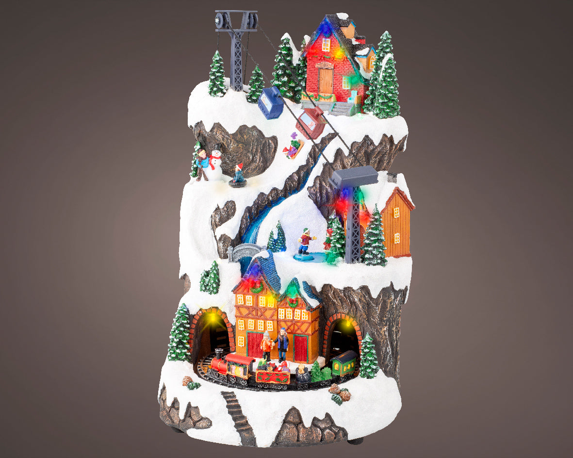 Giostra natalizia 'Villaggio con sciatori' 25,5x29x40H - Lumineo